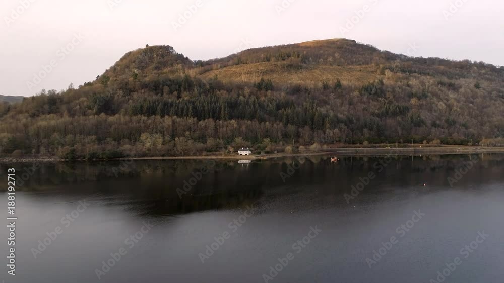 Old House and Mountain Reflected in a Loch in Scotland Old House and Mountain Reflected in a Loch in Scotland