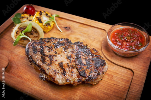 Meat steak on the wooden board photo