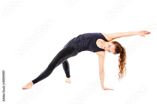 Young fit woman doing pilates excercises isolated on white background