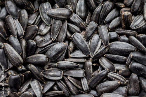 sunflower seeds lying in a plate can serve as a background_