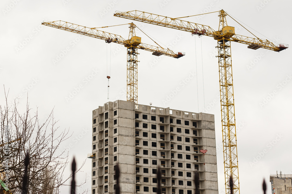 Hoisting cranes and building of new apartments Hoisting cranes and building of new apartments