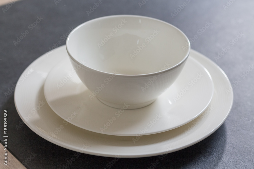 Table dinner Setting White round plate with bowl close up on dark background Table dinner Setting White round plate with bowl close up on dark background