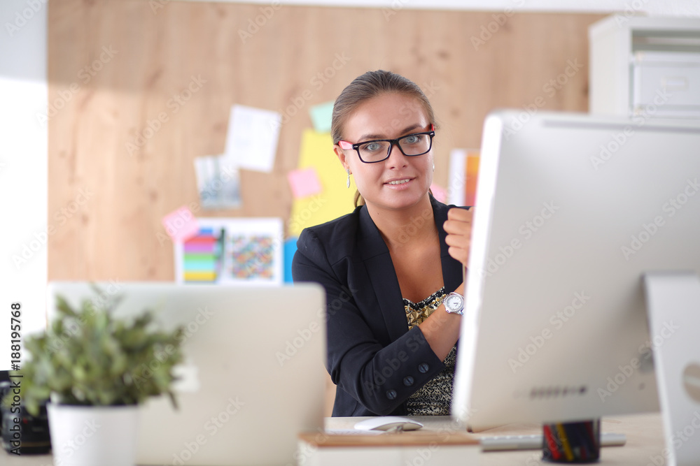 Portrait of an attractive young businesswoman sitting in front of a computer.businesswoman . Portrait of an attractive young businesswoman sitting in front of a computer.businesswoman .