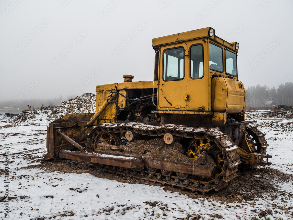 old yellow bulldozer at winter in workplace old yellow bulldozer at winter in workplace