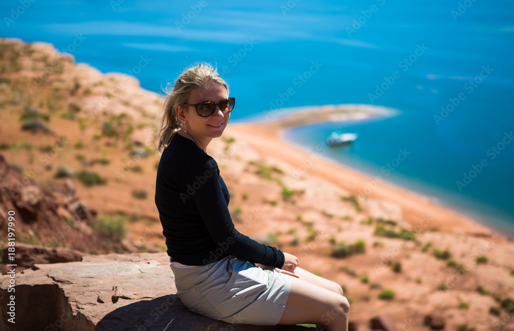 Beautiful young tourist woman watching lake Powell amazing panorama. Famous touristic places in USA. American city travel concept.