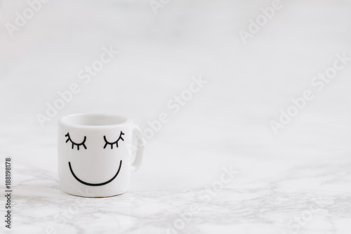 Coffee cup with smiliey face.Negative space