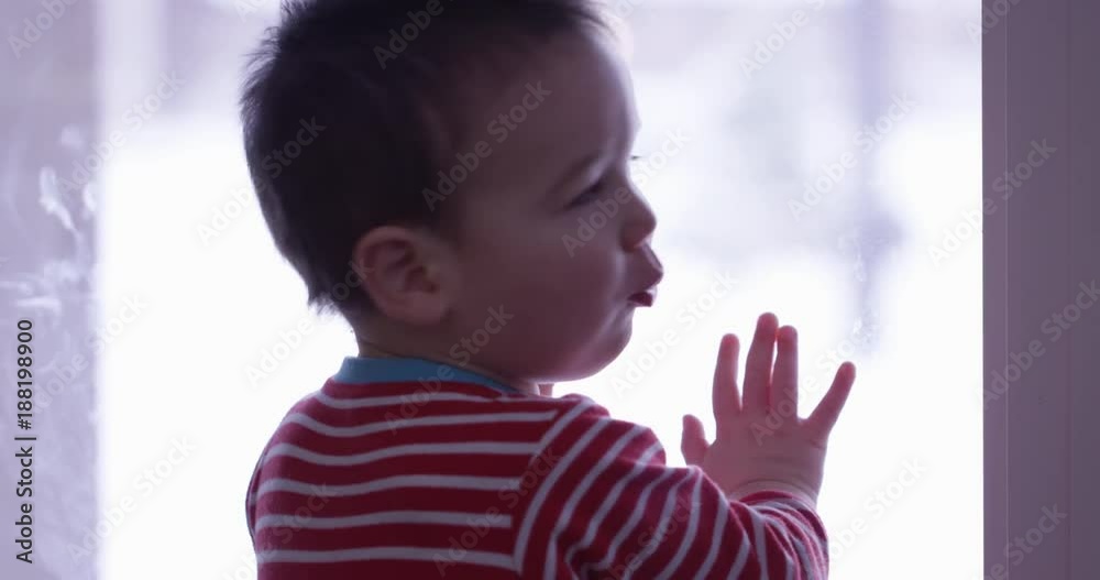 Toddler boy staring our window turns around excitedly Toddler boy staring our window turns around excitedly