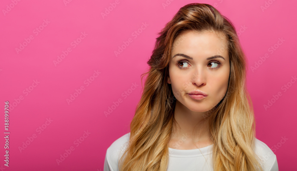 Portrait of girl on pink background looking at something, copy space Portrait of girl on pink background looking at something, copy space