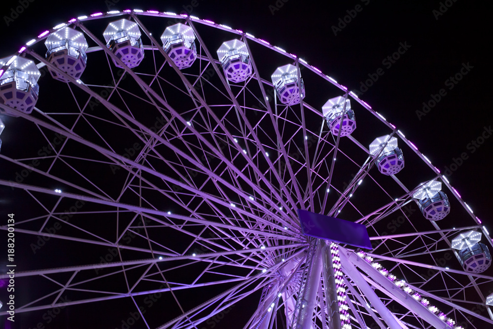 Violet ferris wheel illuminated at night Violet ferris wheel illuminated at night