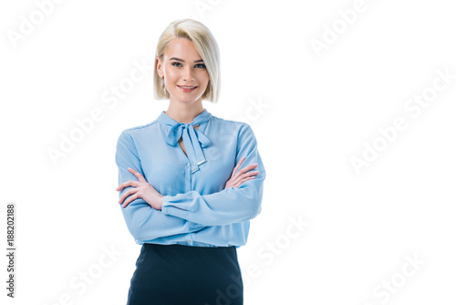 beautiful smiling businesswoman posing in formal wear with crossed arms, isolated on white photo