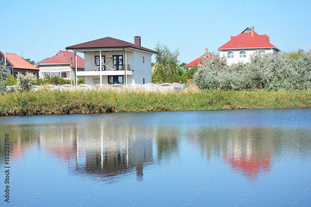 Building house construction with metal roof on the river bank with beautiful view. Building house construction with metal roof on the river bank with beautiful view.