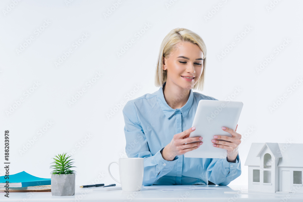portrait of smiling real estate agent with tablet at workplace portrait of smiling real estate agent with tablet at workplace
