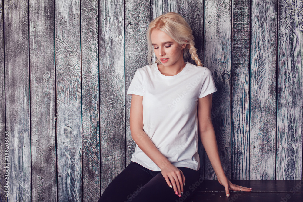 Fototapeta premium Beautiful girl with two braids in a white T-shirt. Mock-up.