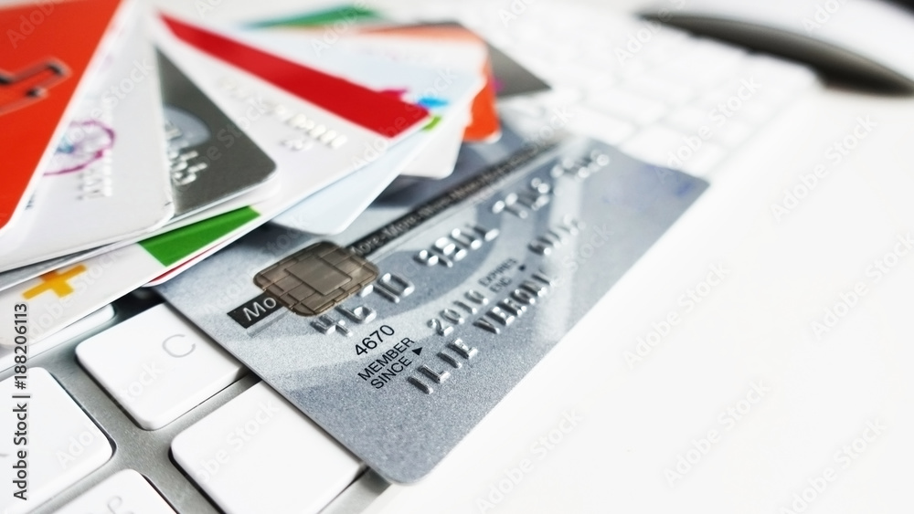 Online transfers or shopping concept with multiple credit cards on white computer keyboard
Online transfers or shopping concept with multiple credit cards on white computer keyboard