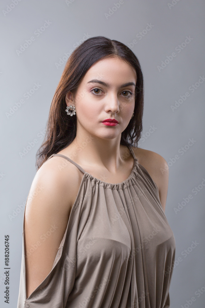 close up portrait of brunette girl with red lips posing over grey background close up portrait of brunette girl with red lips posing over grey background