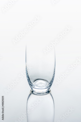 one glass on white reflecting table