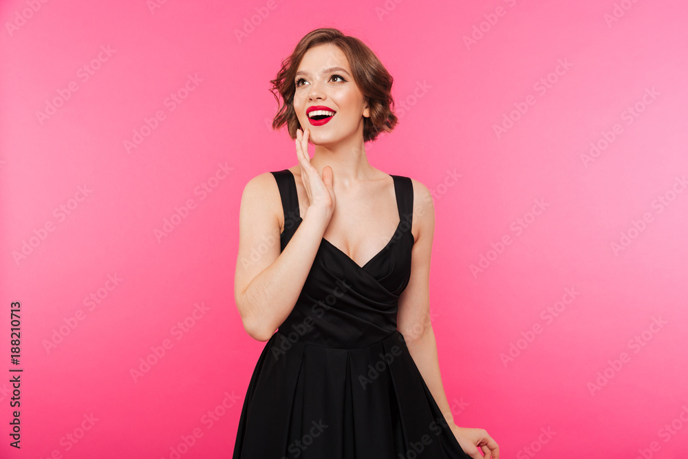 Portrait of a cheerful girl dressed in black dress