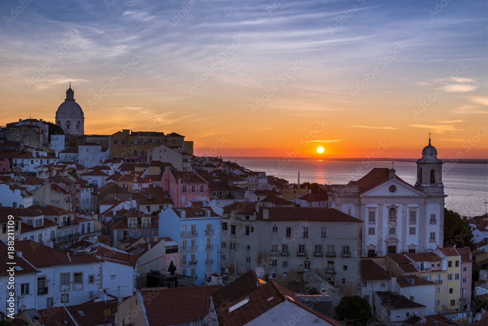 View of the Alfama neighborhood from the Portas do Sol viewpoint at sunrise in Lisbon, Portugal; Concept for travel in Portugal, visit Portugal and most beutiful places in Portugal