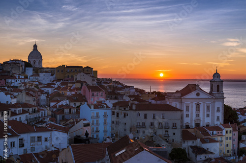 View of the Alfama neighborhood from the Portas do Sol viewpoint at sunrise in Lisbon, Portugal; Concept for travel in Portugal, visit Portugal and most beutiful places in Portugal