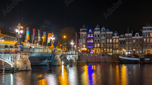 Canvas Print City scenic from Amsterdam at christmas at the Amstel in the Netherlands at nigh