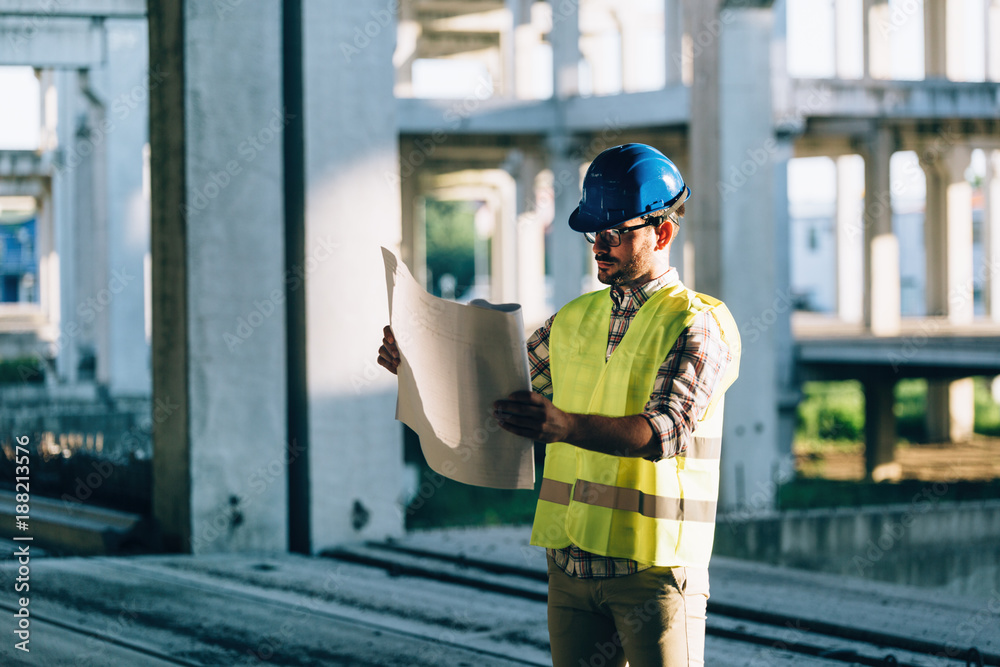 Picture of construction site engineer looking at plan Picture of construction site engineer looking at plan