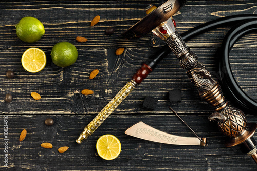 Dismantled parts of hookah on a wooden background with lime frui