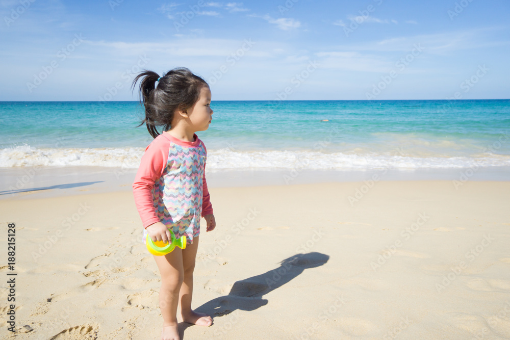Little asian girl playing on beach.Vacation summer and relax concept. Little asian girl playing on beach.Vacation summer and relax concept.