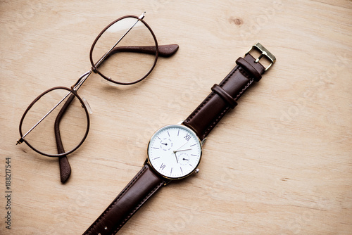 top view of glasses and watch on wooden surface