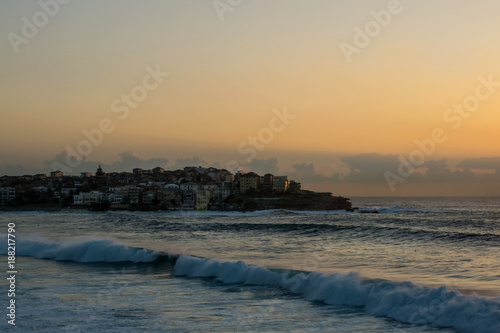 Sunrise over Bondi coastline in Sydney area with huge waves in a foreground