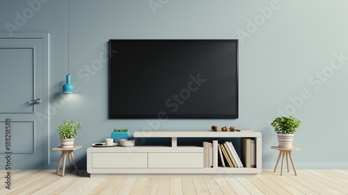 TV on the cabinet in modern living room have plants and book on blue wall background,3d rendering