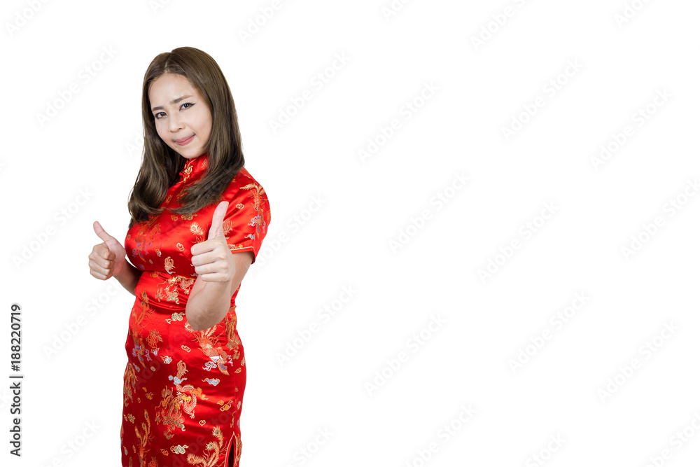 Beautiful asian woman wearing cheongsam show hand thumbs up and smiling in Happy Chinese New Year. Beautiful asian woman wearing cheongsam show hand thumbs up and smiling in Happy Chinese New Year.