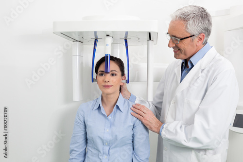 A dentist with his patient doing an x-ray panoramic digital photo