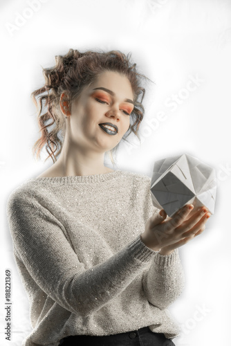 portrait of a beautiful caucasian curly hhair young business woman holds paper sphere in her hands, business idea concept. photo