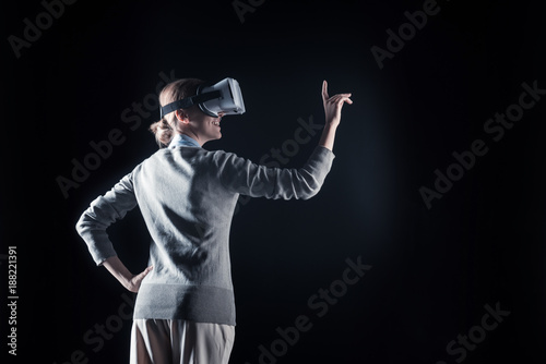 New experience. Delighted nice happy woman smiling and being in virtual reality while enjoying it © Viacheslav Yakobchuk