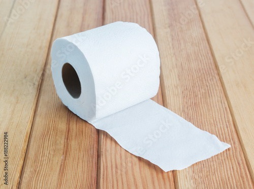White toilet tissue roll on wood