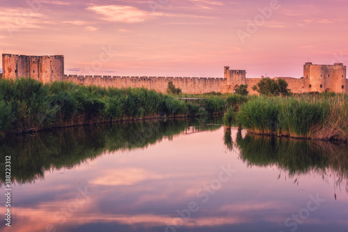 Scenic sunset view of the ancient city wall of the Aigues-Mortes  famous medieval fortress in South France  Camargue national park