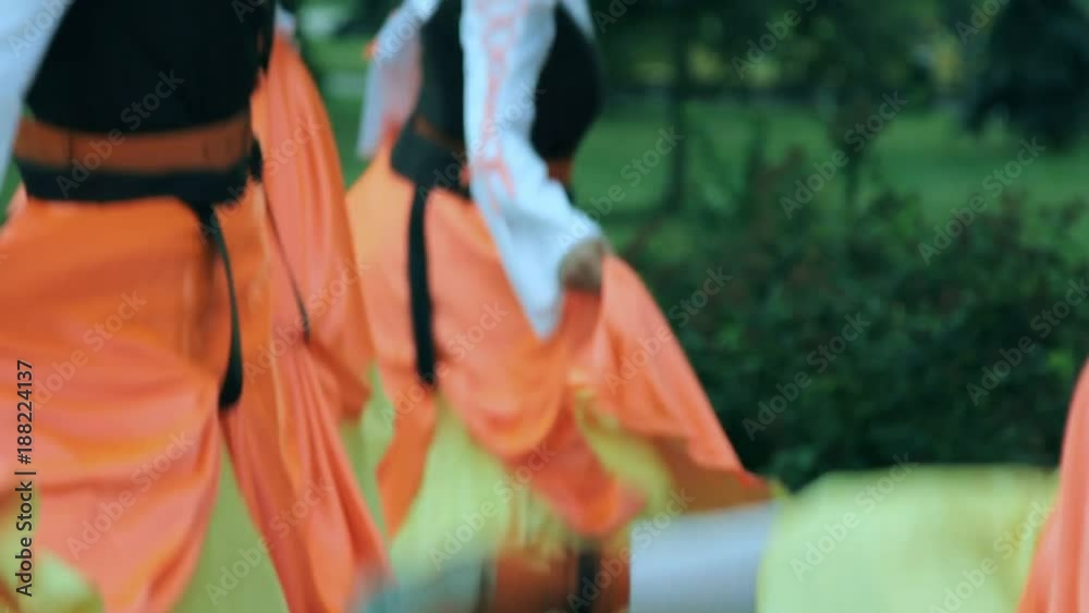 Folklore dance outdoors. Closeup of group of people dancing Irish national dance. Folk dancers background. National entertainment in traditional dress Folklore dance outdoors. Closeup of group of people dancing Irish national dance. Folk dancers background. National entertainment in traditional dress