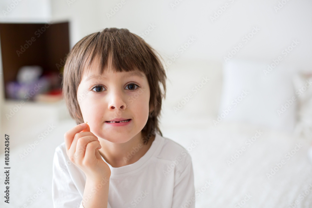 Little smiling child boy hand pointing his first baby milk tooth fall out Little smiling child boy hand pointing his first baby milk tooth fall out