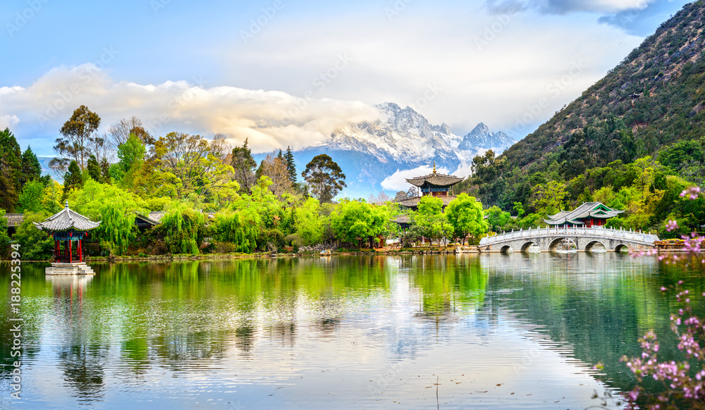 Black Dragon Pool and Jade Dragon Snow Mountain. It's a famous pond in the scenic Jade Spring Park (Yu Quan Park) located at the foot of Elephant Hill, old Town of Lijiang in Yunnan, China.