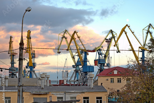 Торговый порт, Shipping.cargo to harbor.Aerial view.Top view.. Cargo cranes in the dock by the water over blue sky photo