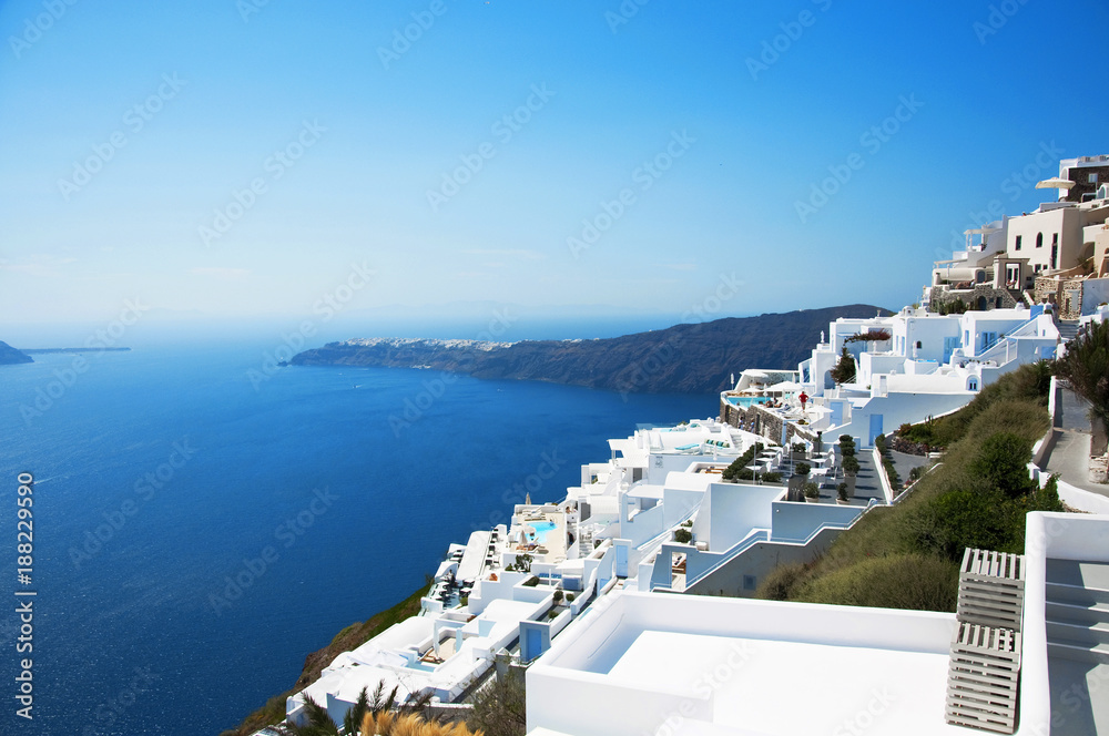 Fototapeta premium Santorini Island, Greece, Europe. Traditional white Greek architecture over Caldera, a beautiful landscape with a blue sky and famous white houses.