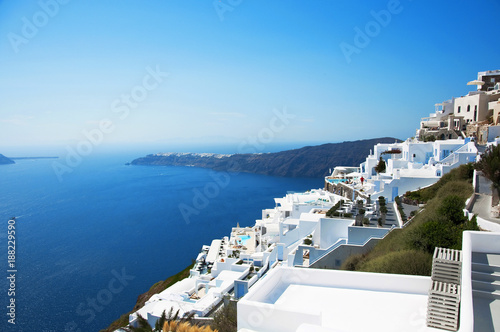 Santorini Island, Greece, Europe. Traditional white Greek architecture over Caldera, a beautiful landscape with a blue sky and famous white houses. © olgaarkhipenko
