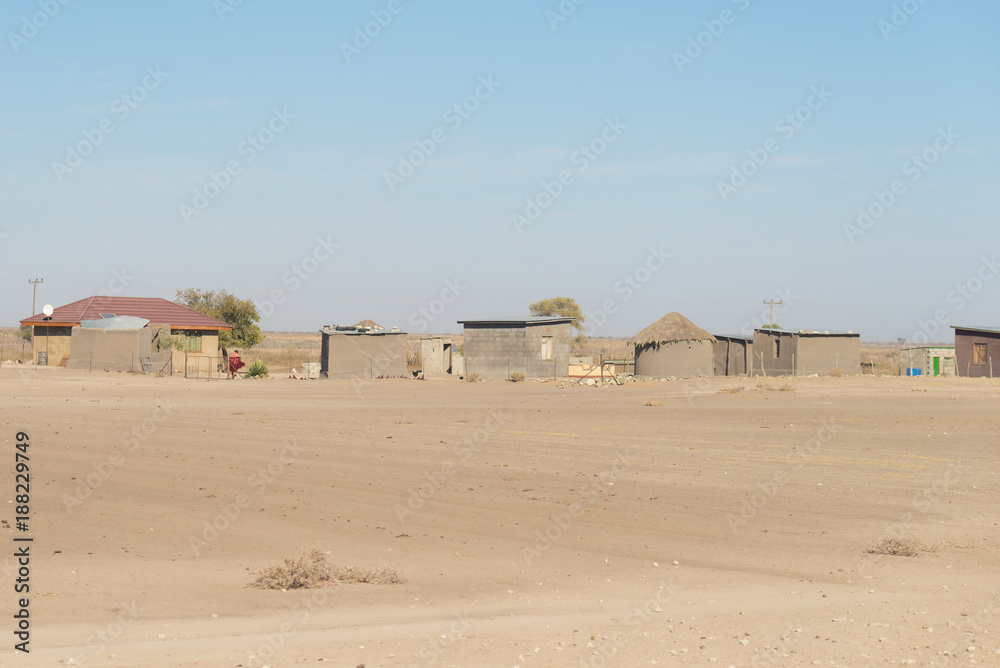 Mud straw and wooden hut with thatched roof in the bush. Local village in the rural Caprivi Strip, the most populated region in Namibia, Africa. Mud straw and wooden hut with thatched roof in the bush. Local village in the rural Caprivi Strip, the most populated region in Namibia, Africa.
