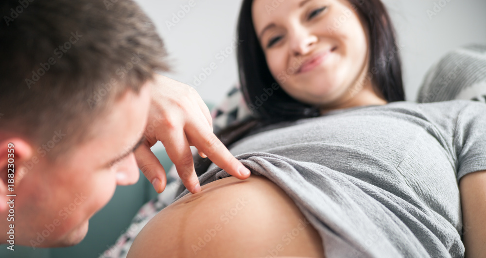 Man touching pregnant belly of woman, enjoying pregnancy time Man touching pregnant belly of woman, enjoying pregnancy time
