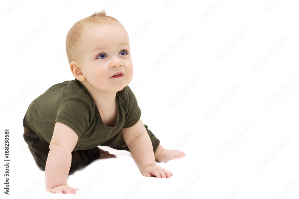 Adorable infant boy sitting on the white blanket and looking up Adorable infant boy sitting on the white blanket and looking up