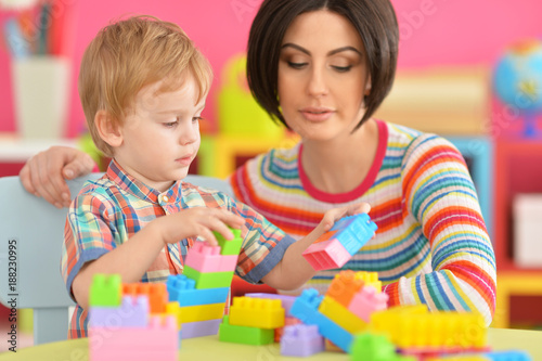 Young mother playing with son