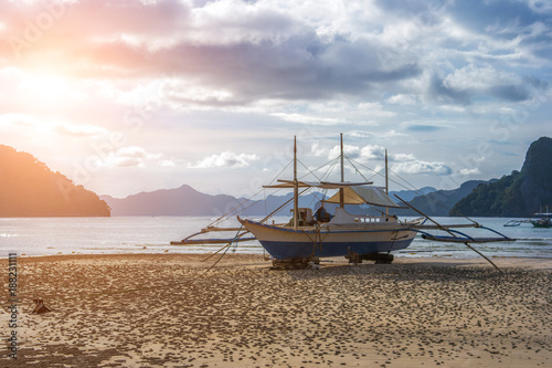 Bangka boat is standing on the beach at sunset, Philippines