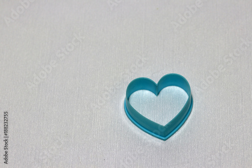 Heart shaped of dessert plastic mold in blue color isolated on white background. The concept of in love in dessert shop or Valentine day.