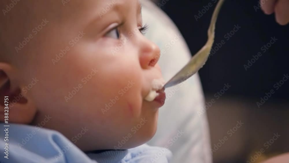 A little boy is fed from a spoon. HD, 1920x1080, slow motion A little boy is fed from a spoon. HD, 1920x1080, slow motion