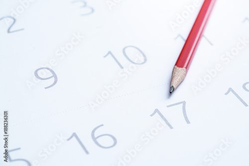 close up of calendar with the red pencil, planning for business meeting or travel planning concept